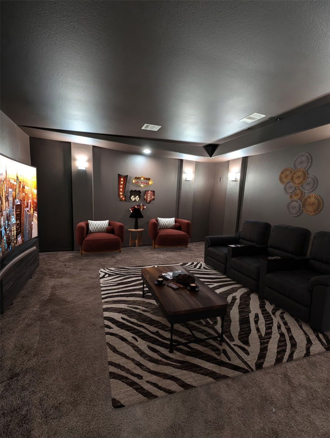 Large home theater with modern lighting, and warm tones, creating an inviting space for entertainment.