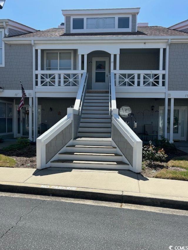 View of front facade featuring stairway