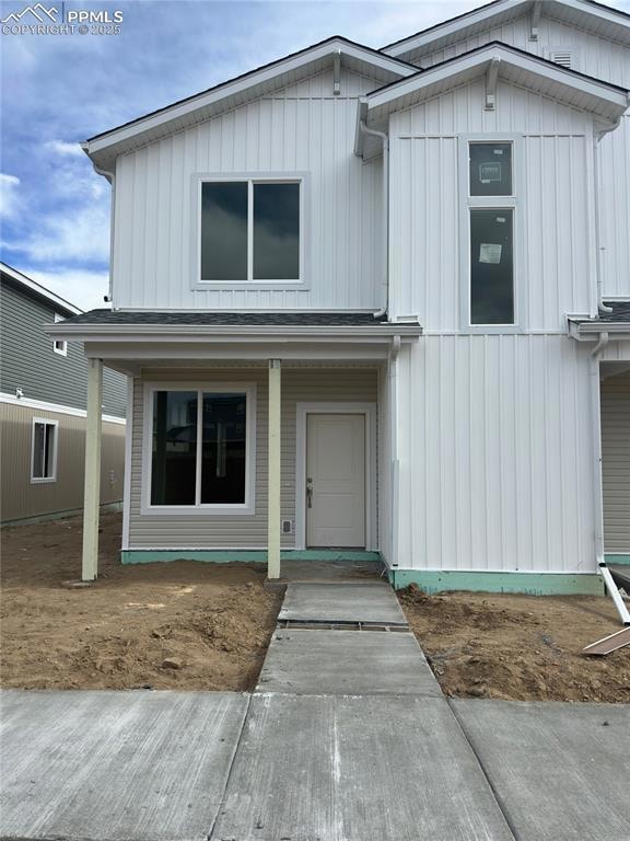 View of front of home with a porch and board and b