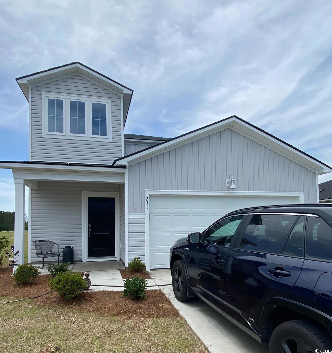 View of front of property featuring an attached ga