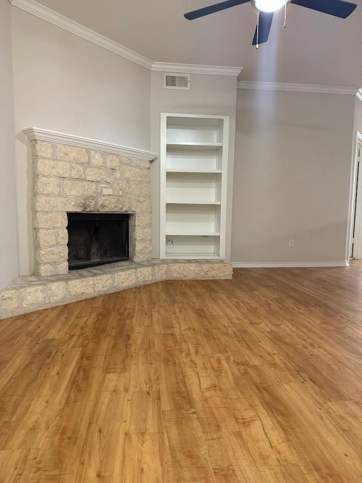 Unfurnished living room featuring a ceiling fan, 