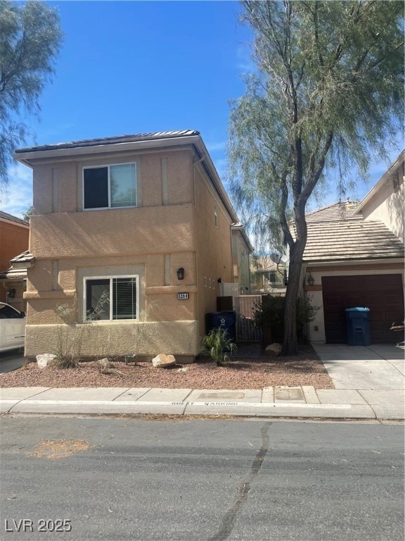 View of property exterior with a garage, stucco si
