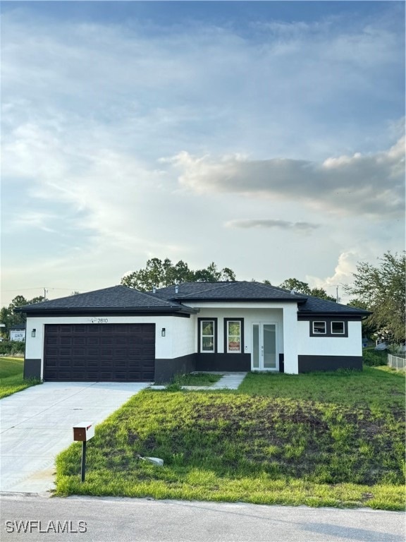 View of front facade with stucco siding, an attach