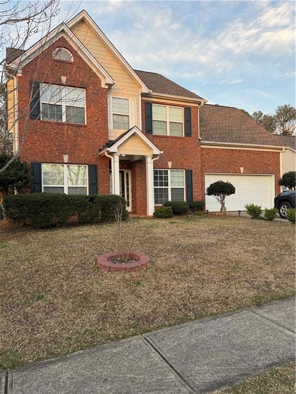 View of front of house with an attached garage, br