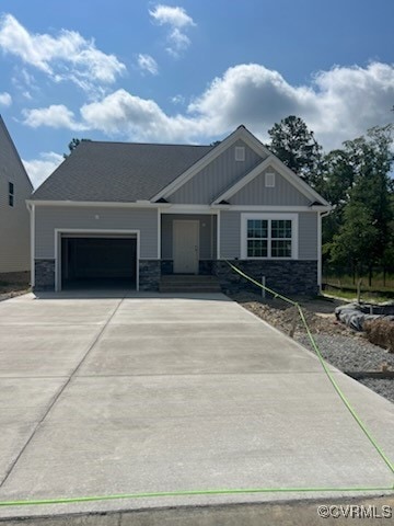 Craftsman house with concrete driveway, a garage,