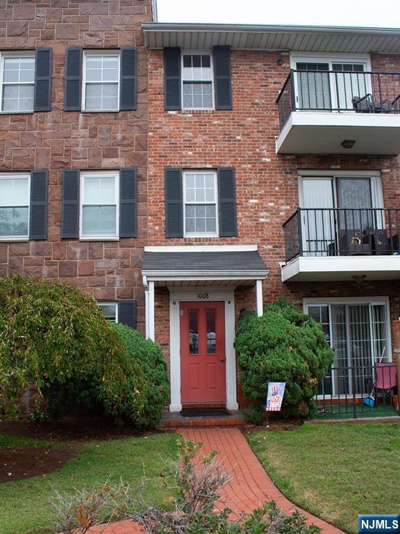 The front view of the ground floor features a welcoming entrance with a small porch and large front windows that bring in plenty of natural light.