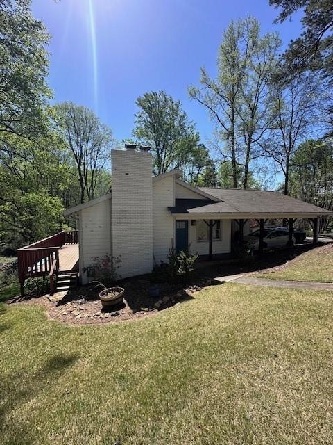 View of side of home featuring a carport, a fire p
