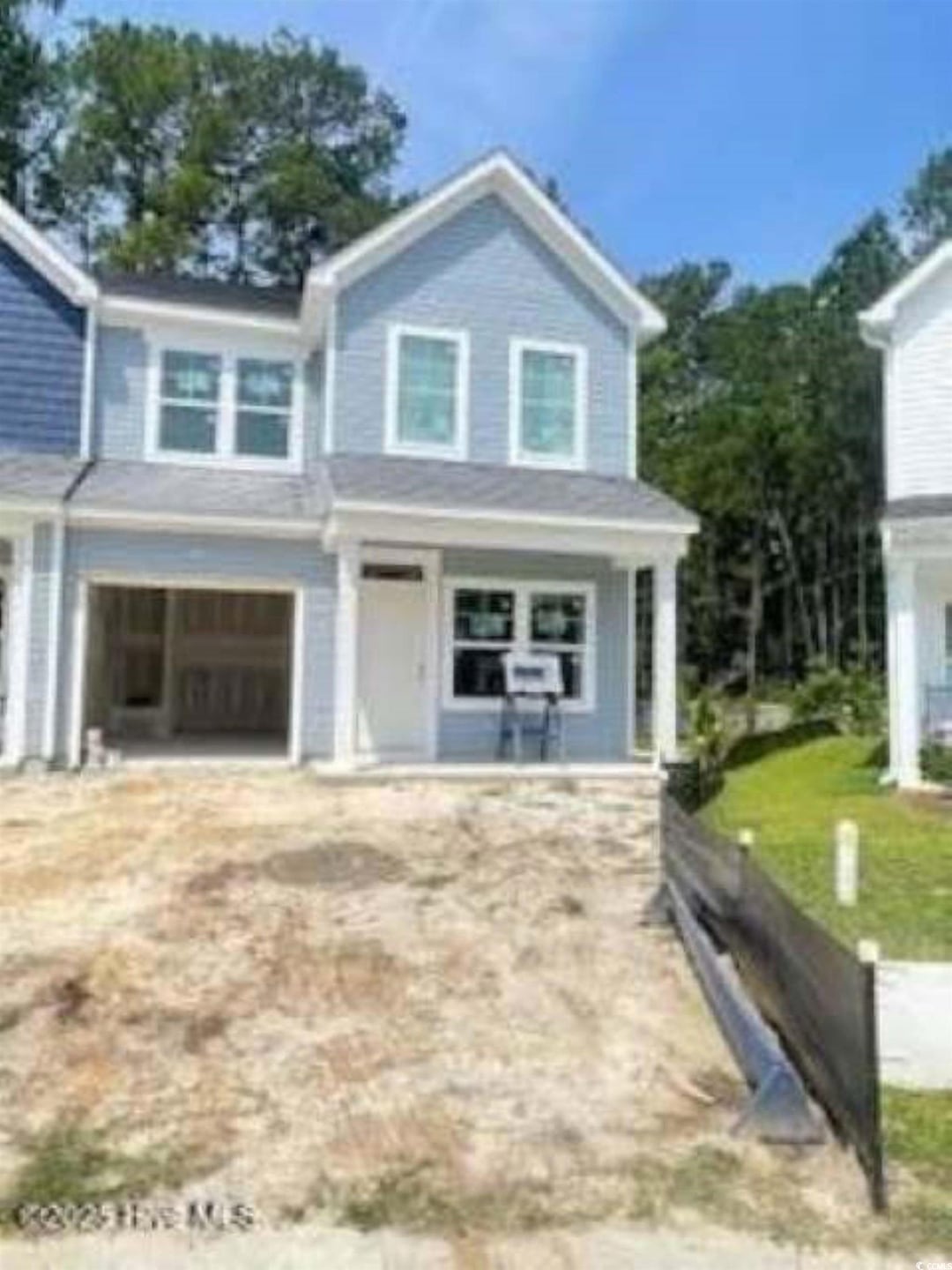 View of front of home with covered porch and a garage