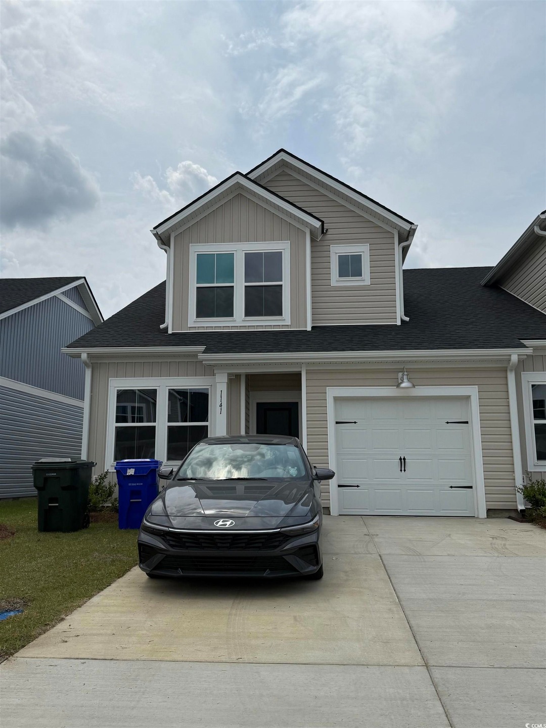 Craftsman house with driveway, roof with shingles,