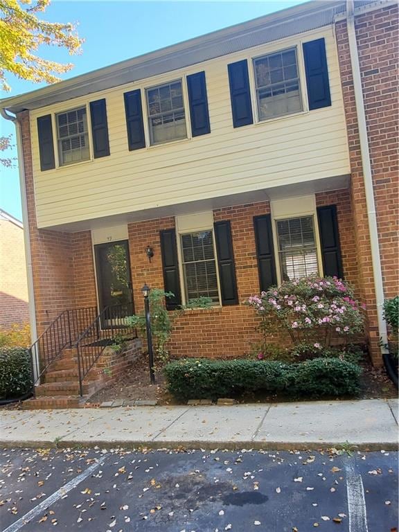 View of front of property with brick siding and covered porch