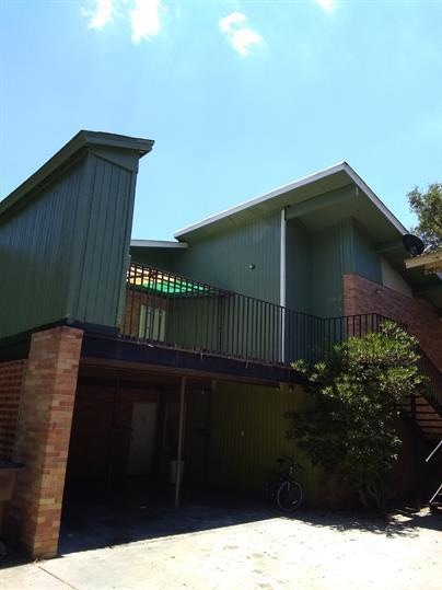 Rear view of house featuring a wooden deck