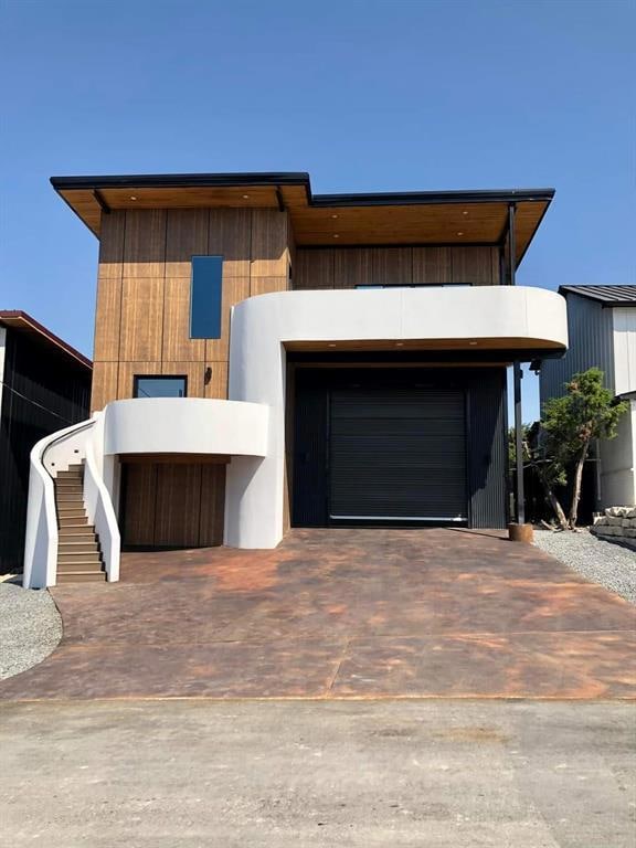 Modern home featuring driveway and a garage