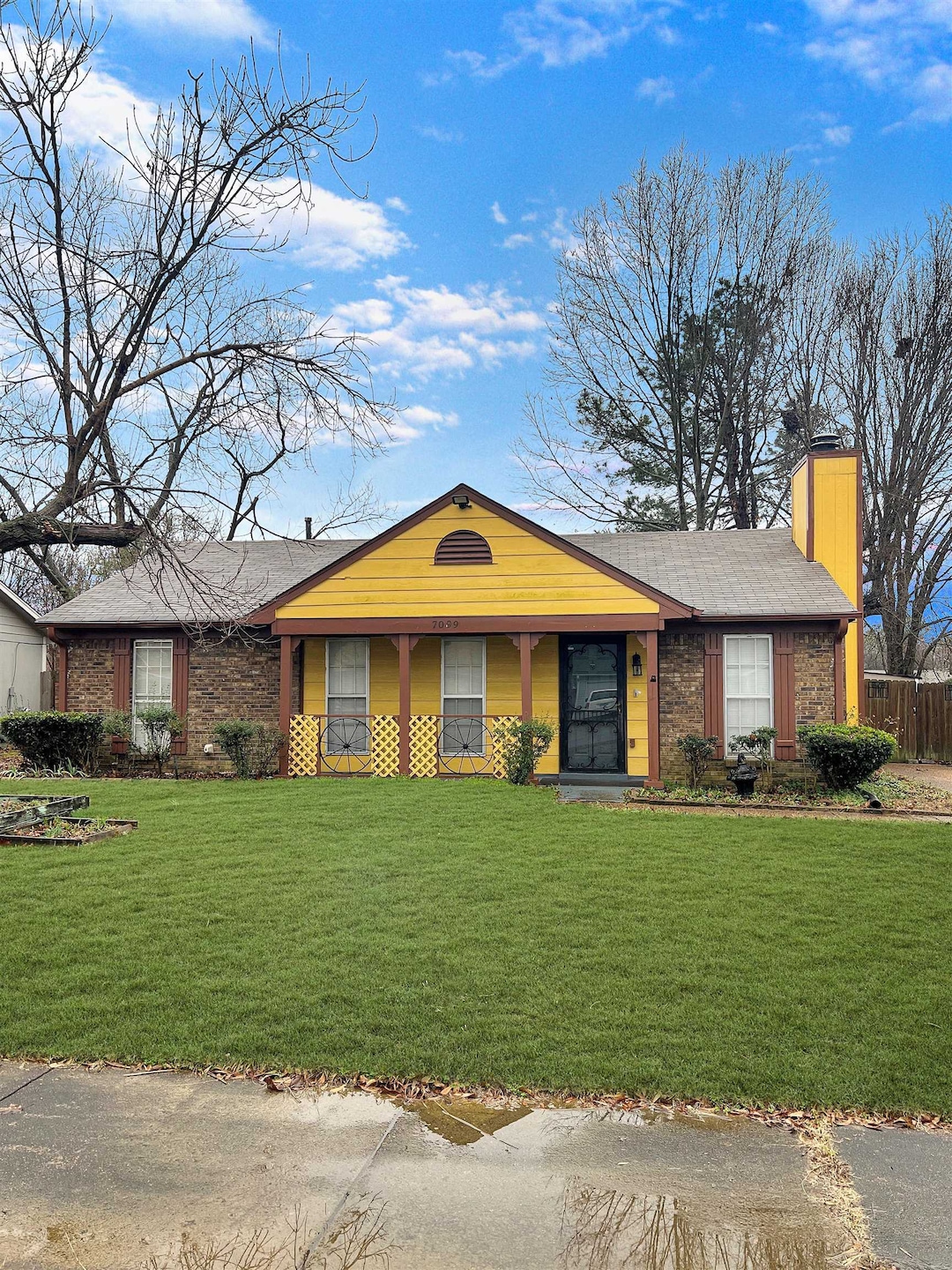 Single story home featuring brick siding, a front 