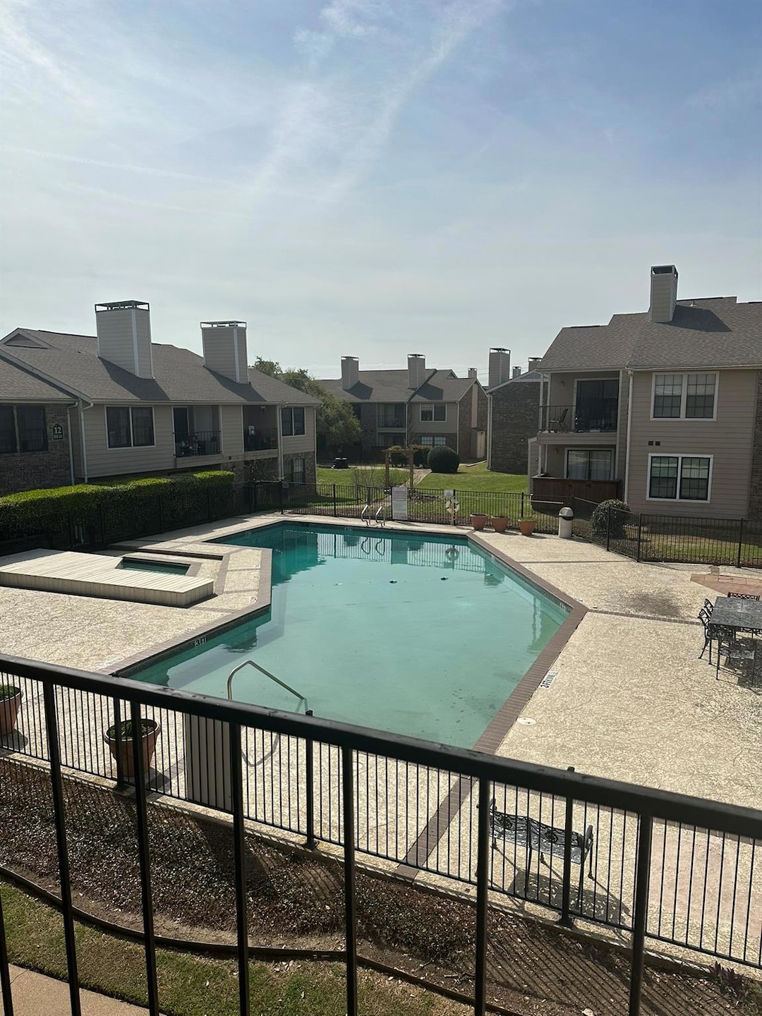 Pool with fence, a patio, and a residential view