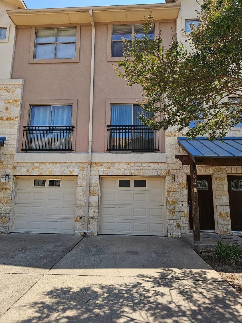 View of building exterior featuring a garage and 