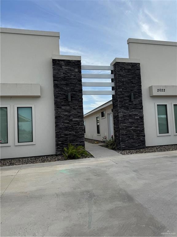 View of home's exterior with stucco siding and stone siding