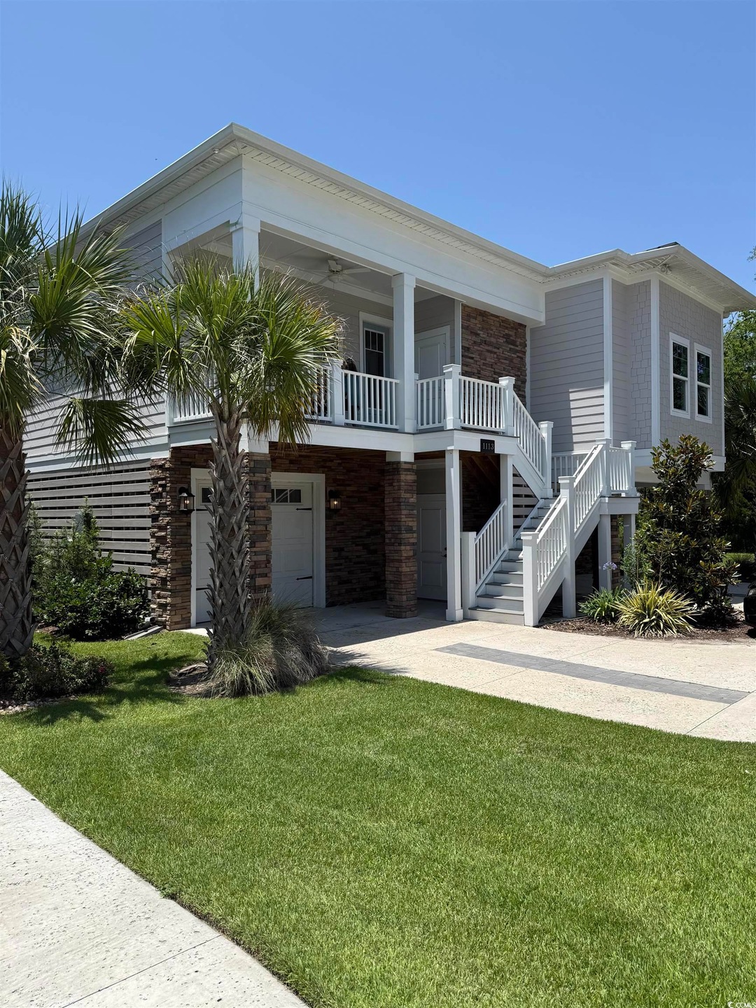 View of front of home featuring a front lawn, stairs, and a porch
