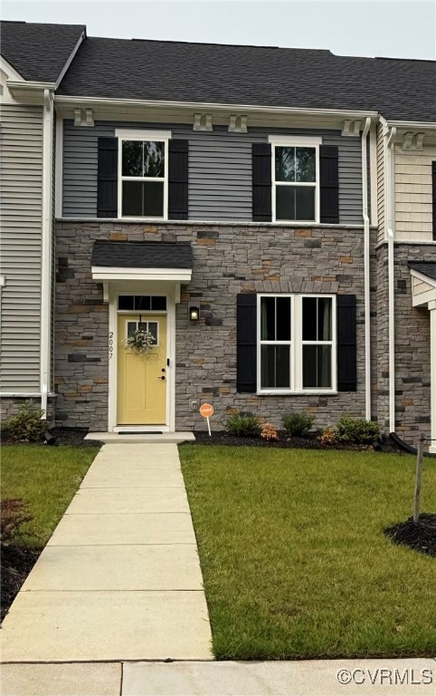 View of front of house with stone siding and a fro