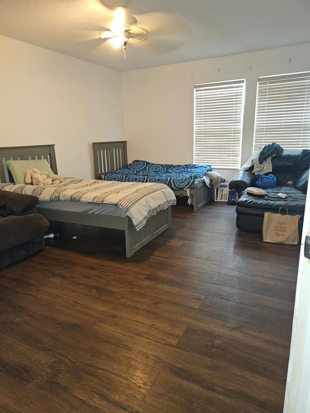 Bedroom with ceiling fan and dark wood-type flooring