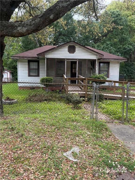 View of front of home featuring a porch and a gate