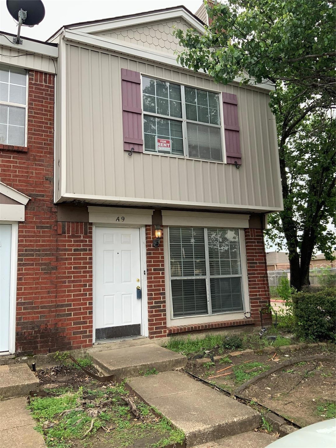 View of front of home featuring brick siding