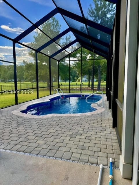 View of Saltwater swimming pool, lanai, fenced bac