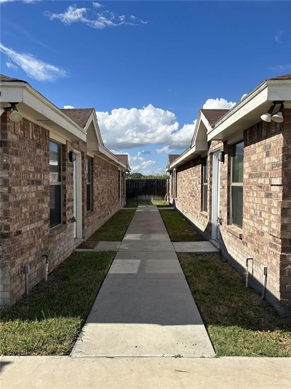View of side of property featuring brick siding