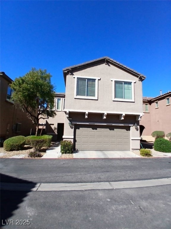 View of front of home featuring driveway, an attac