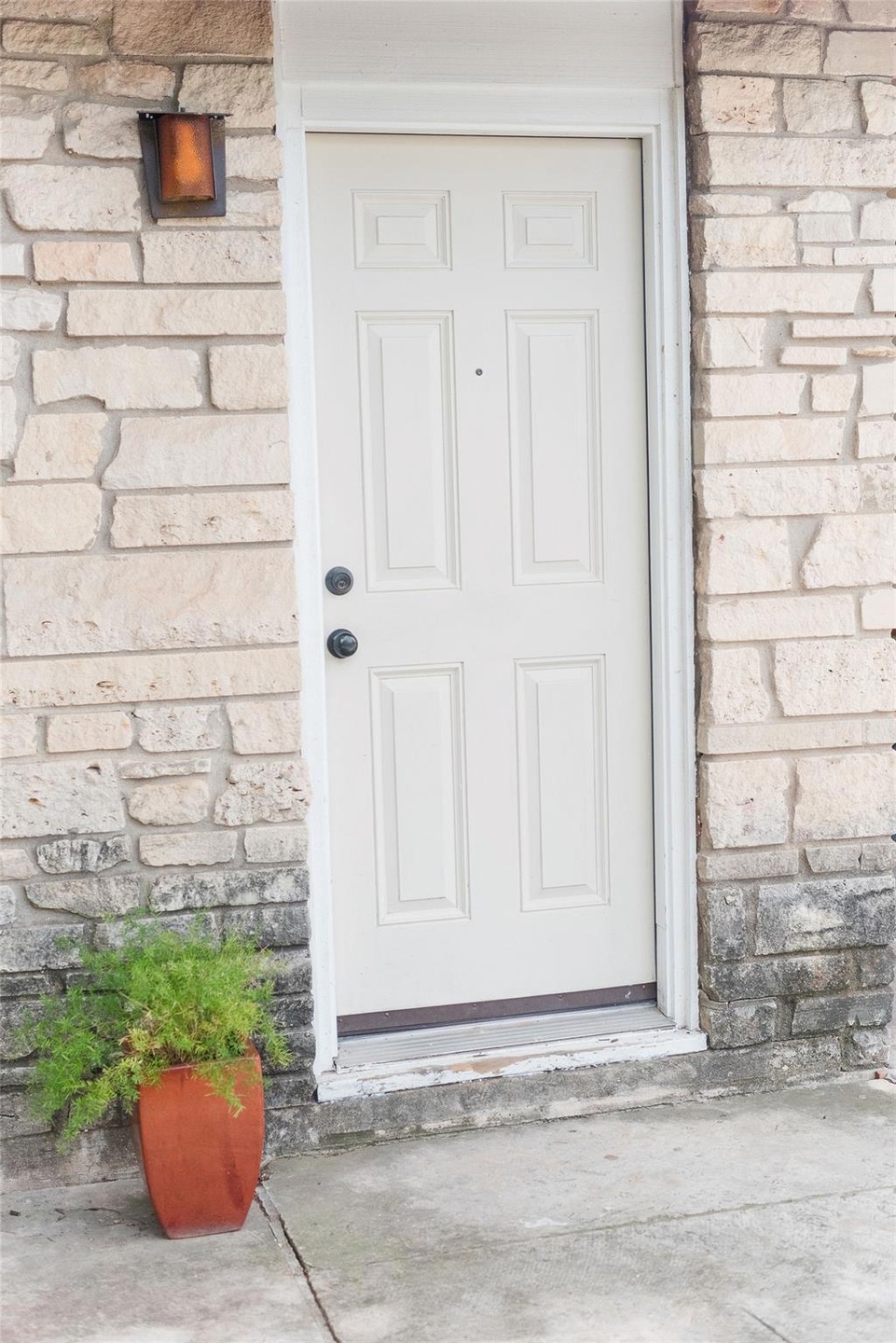 Entrance to property with stone siding