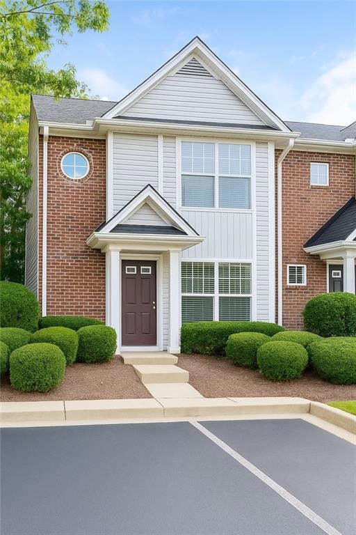 View of front facade featuring brick siding