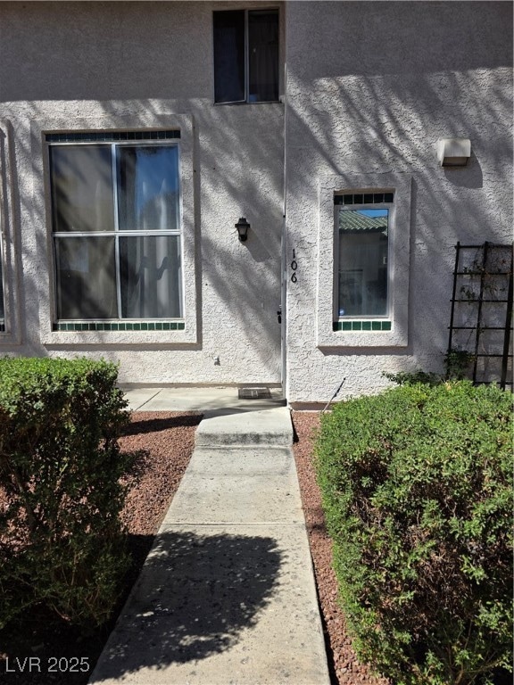 Doorway to property with stucco siding