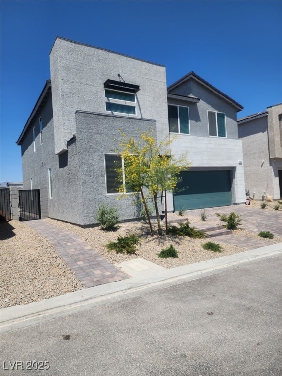 Contemporary house with stucco siding, a garage, a