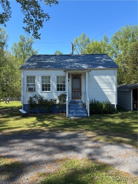 View of front of home with entry steps, a front ya