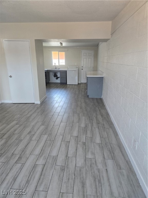 Unfurnished living room featuring washer / clothes