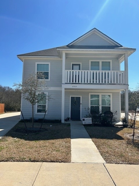 View of front of home featuring a balcony and cove