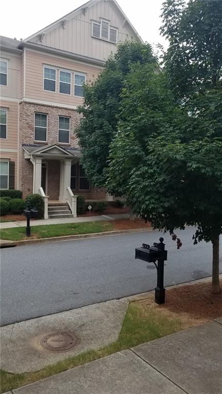 3 story townhouse with front porch.