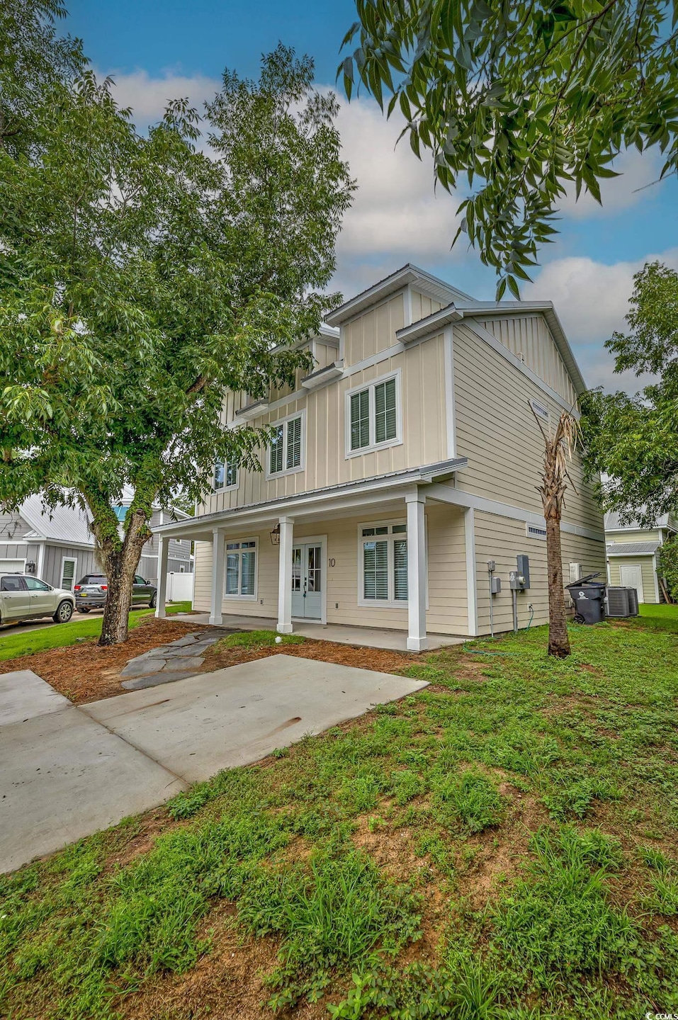 View of front of home featuring a porch and a gara