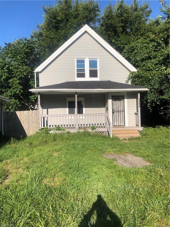 Back of house featuring a lawn