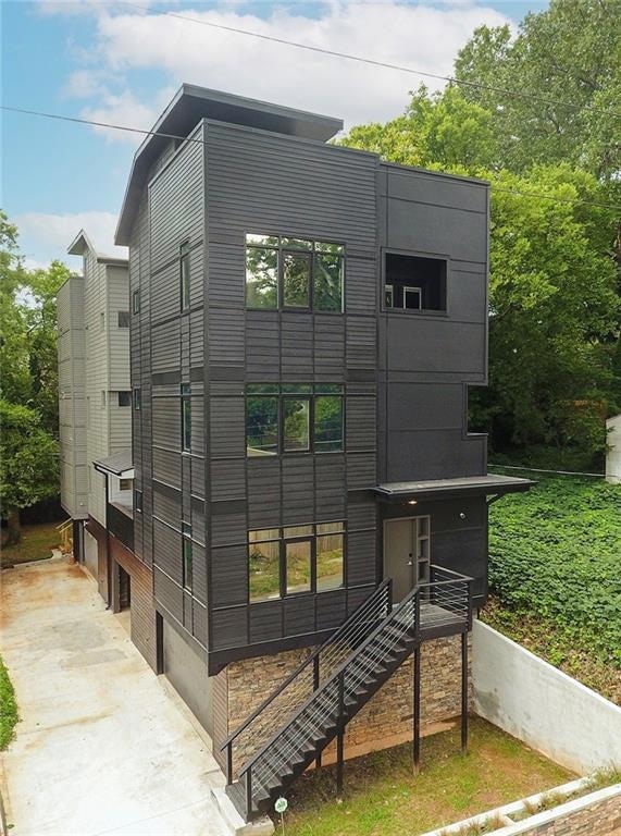 View of front of house with driveway and an attach