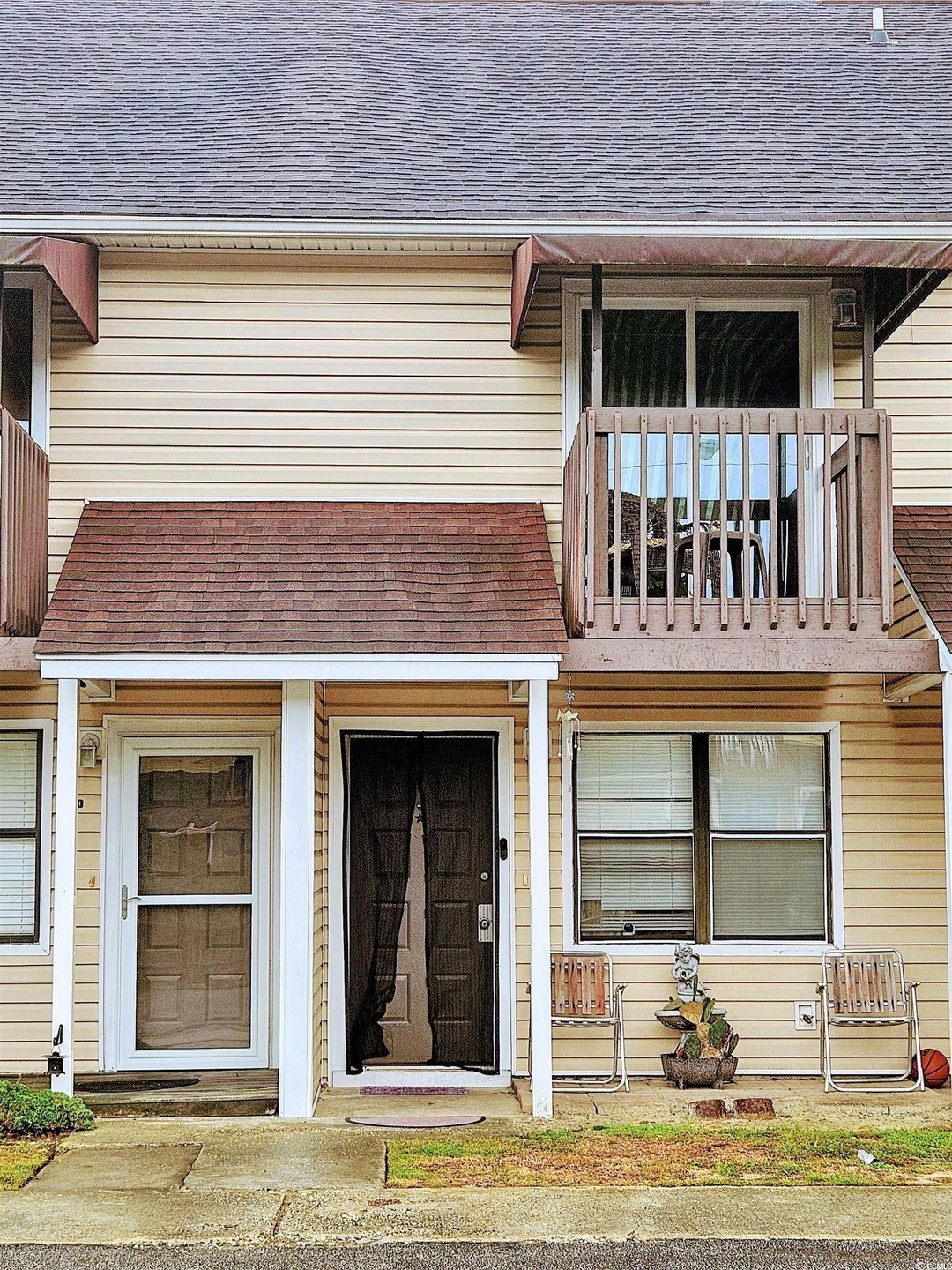 Doorway to property featuring roof with shingles