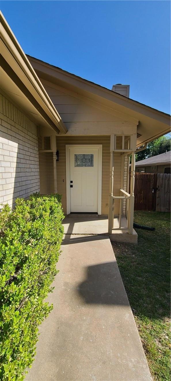 Entrance to property featuring brick siding and a