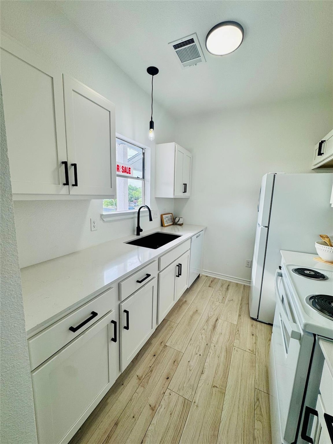 Kitchen featuring visible vents, light wood-style