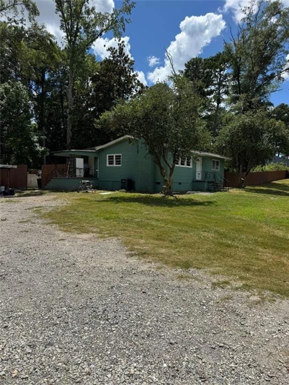 View of home's exterior featuring crawl space and a lawn