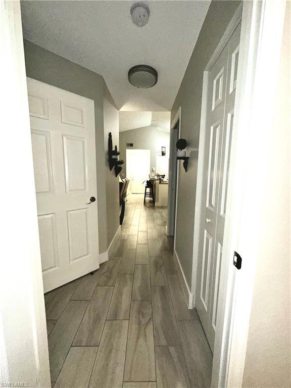 Hall featuring wood finish floors and baseboards
