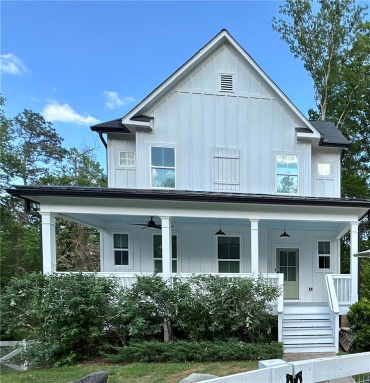 View of front facade featuring board and batten siding, covered porch, and a ceiling fan