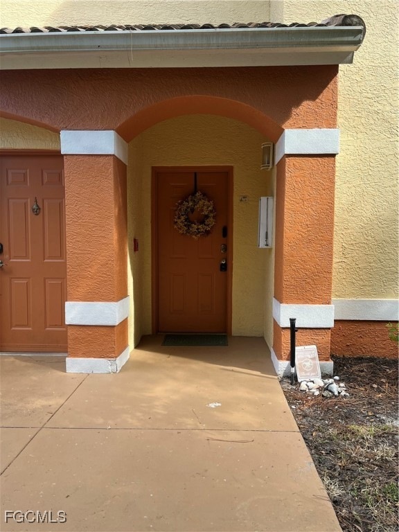 View of exterior entry featuring stucco siding