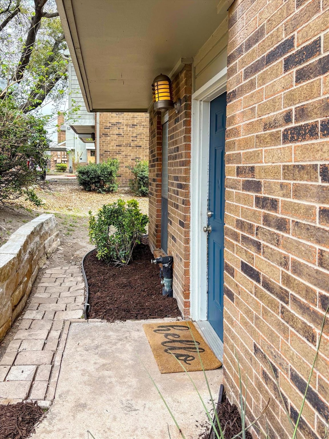 Doorway to property featuring brick siding