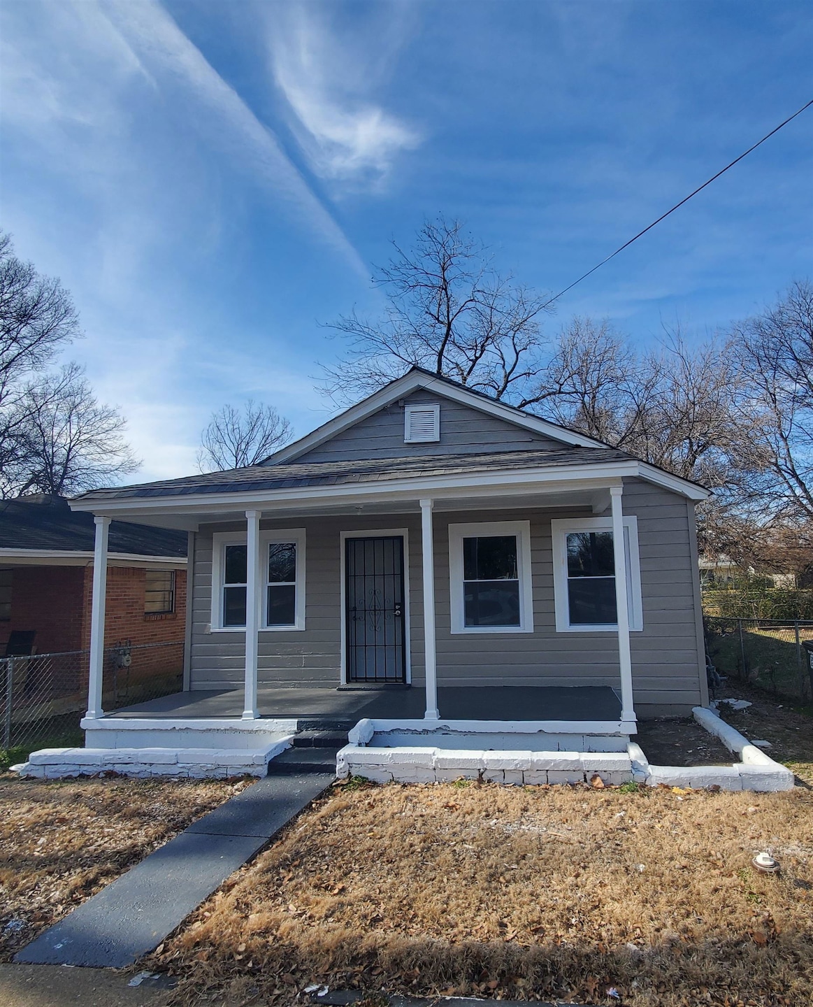 Bungalow-style home featuring covered porch and fe