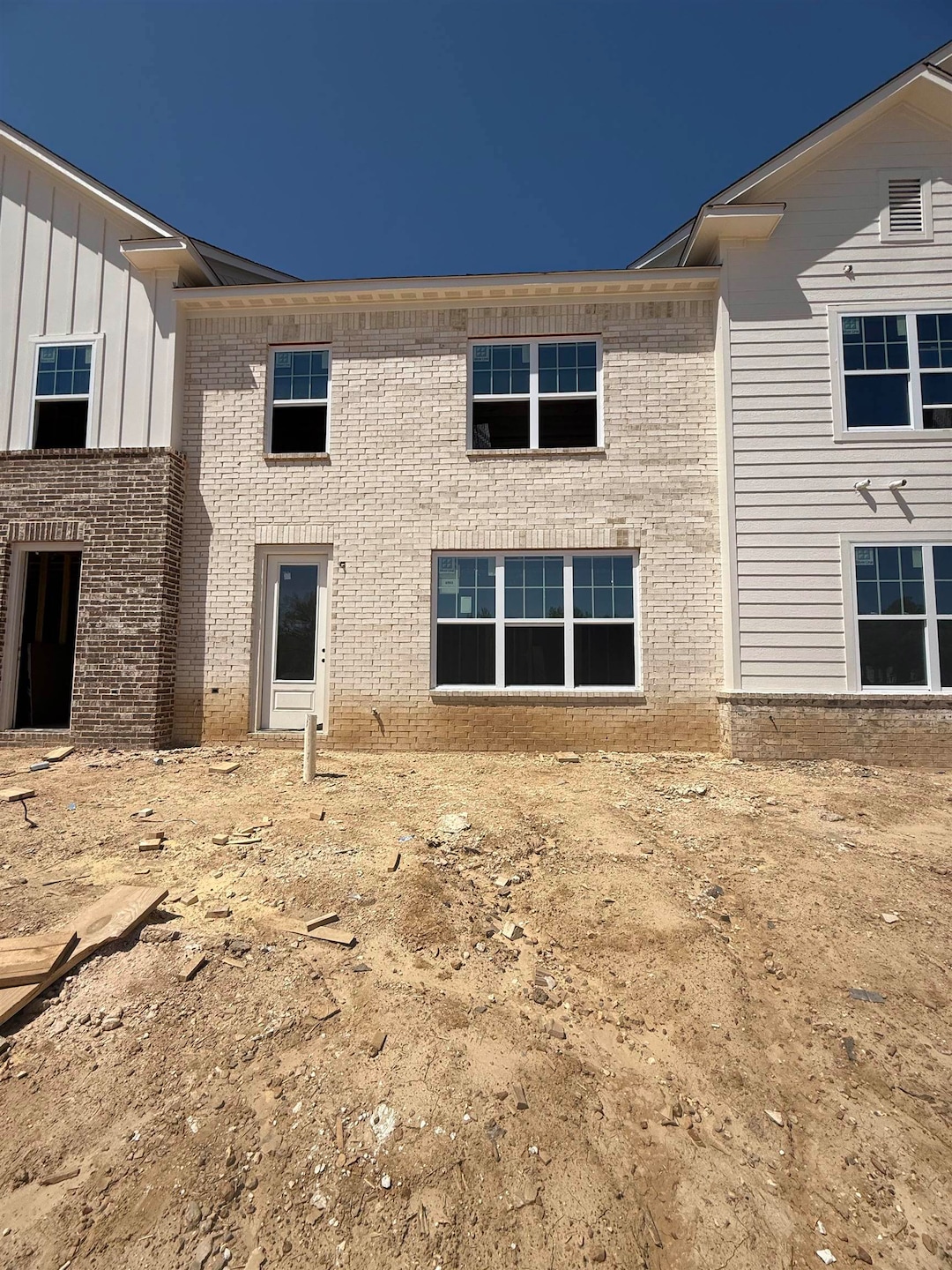 Rear view of house featuring board and batten sidi