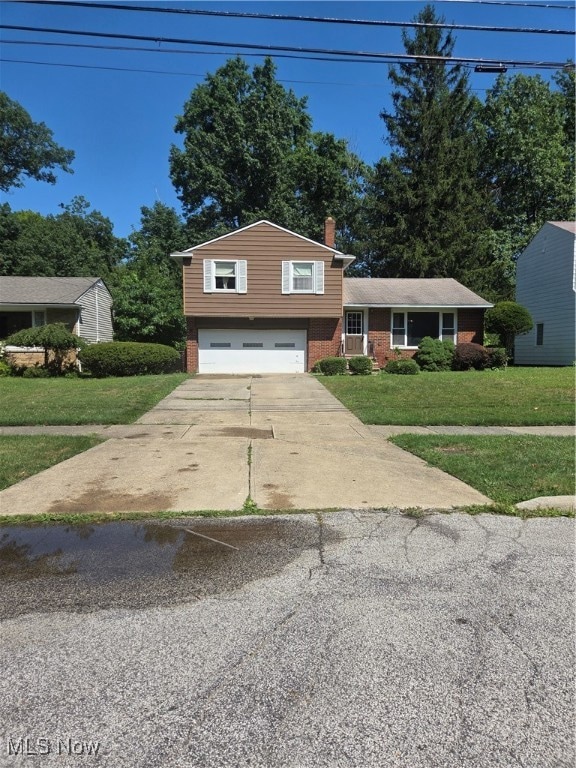 Split level style home featuring a front lawn ,2 car garage and concrete driveway